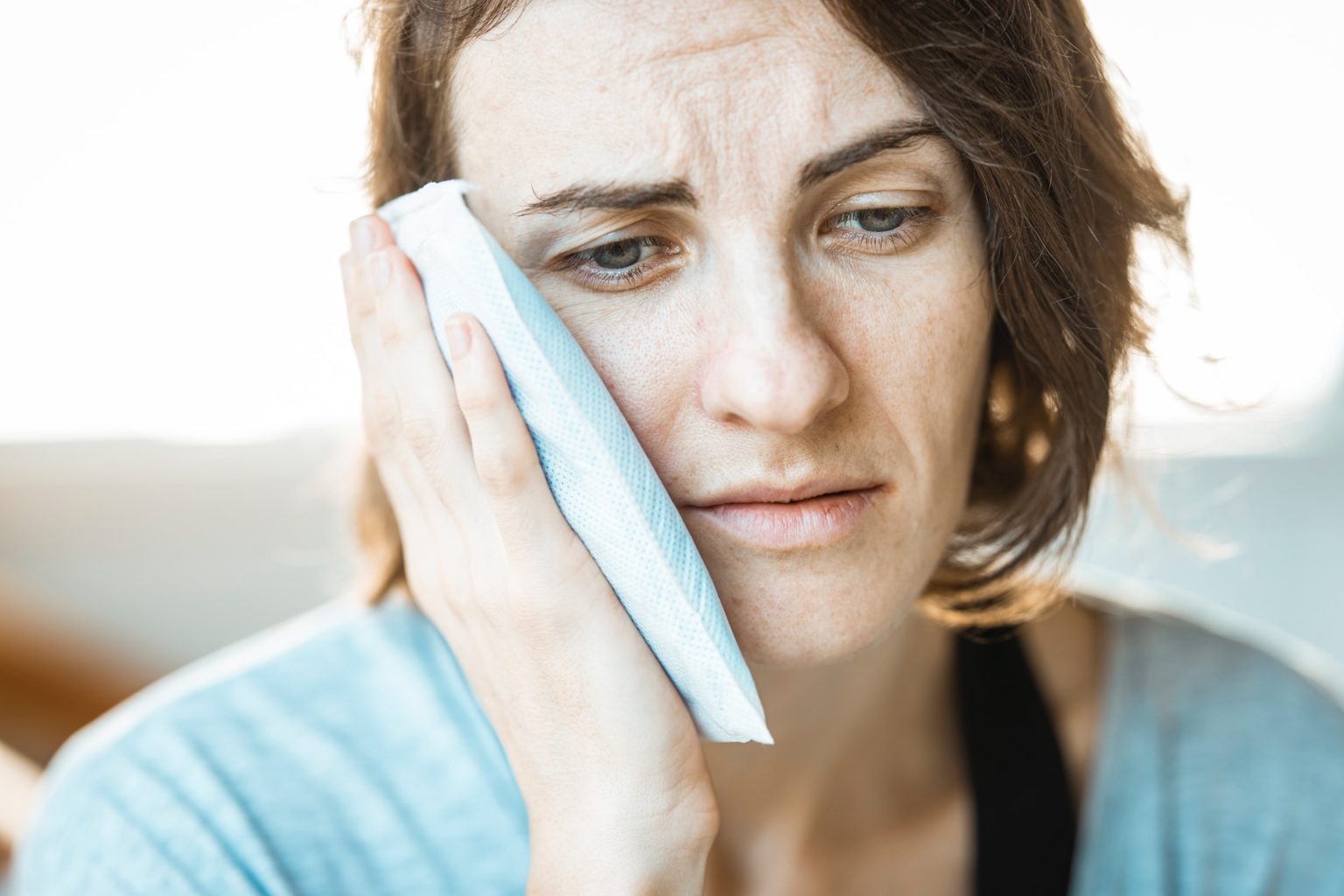 a woman holding her face