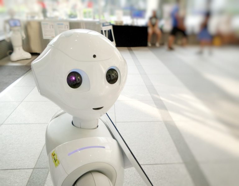 a white robot on a tile floor